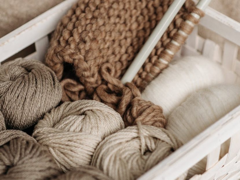 white and brown yarns in basket